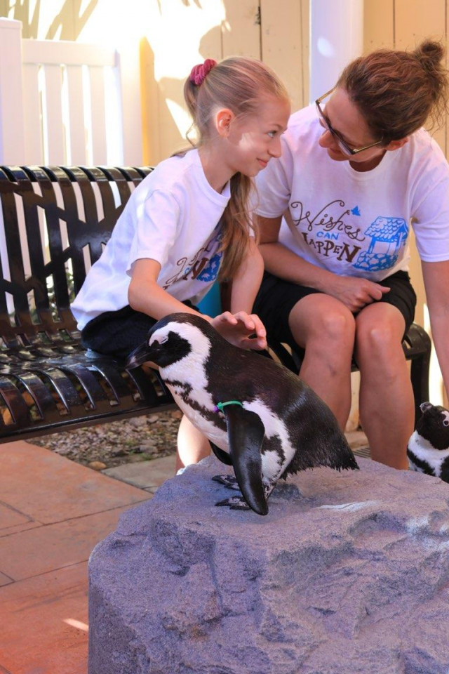 Shae and mom with penguin at zoo