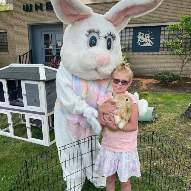 Hallie with stuffed rabbit holding real rabbit