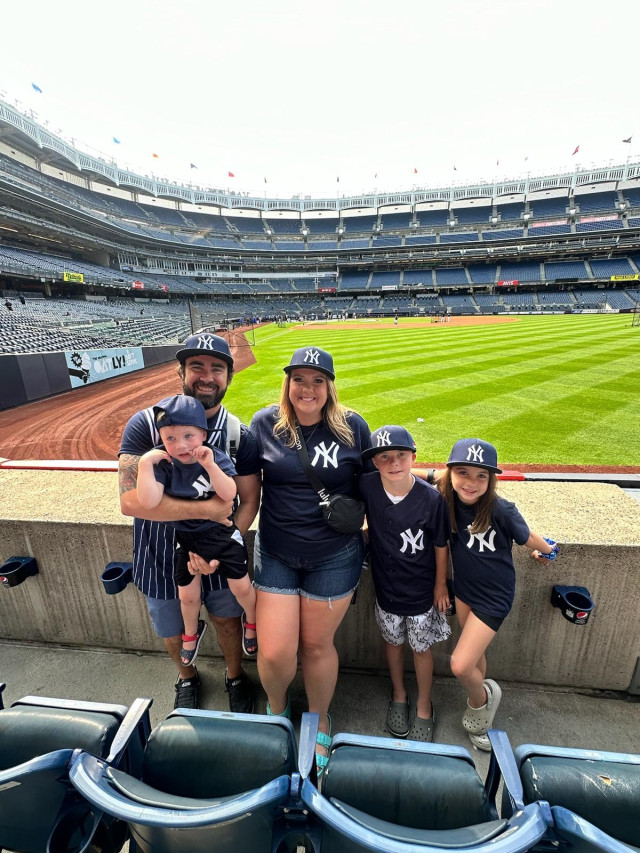 Family with field shot at batting practice