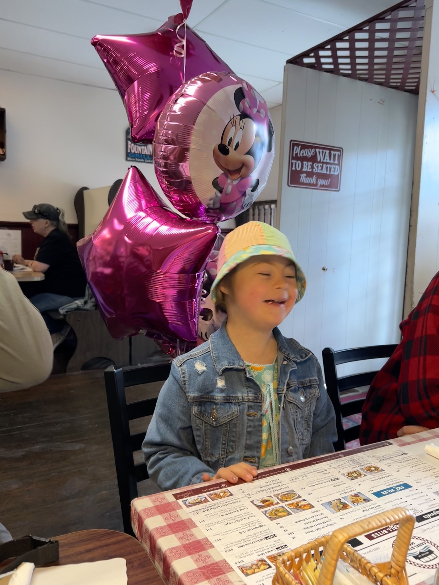 Lucie Smiling with Hat and Menu at WP