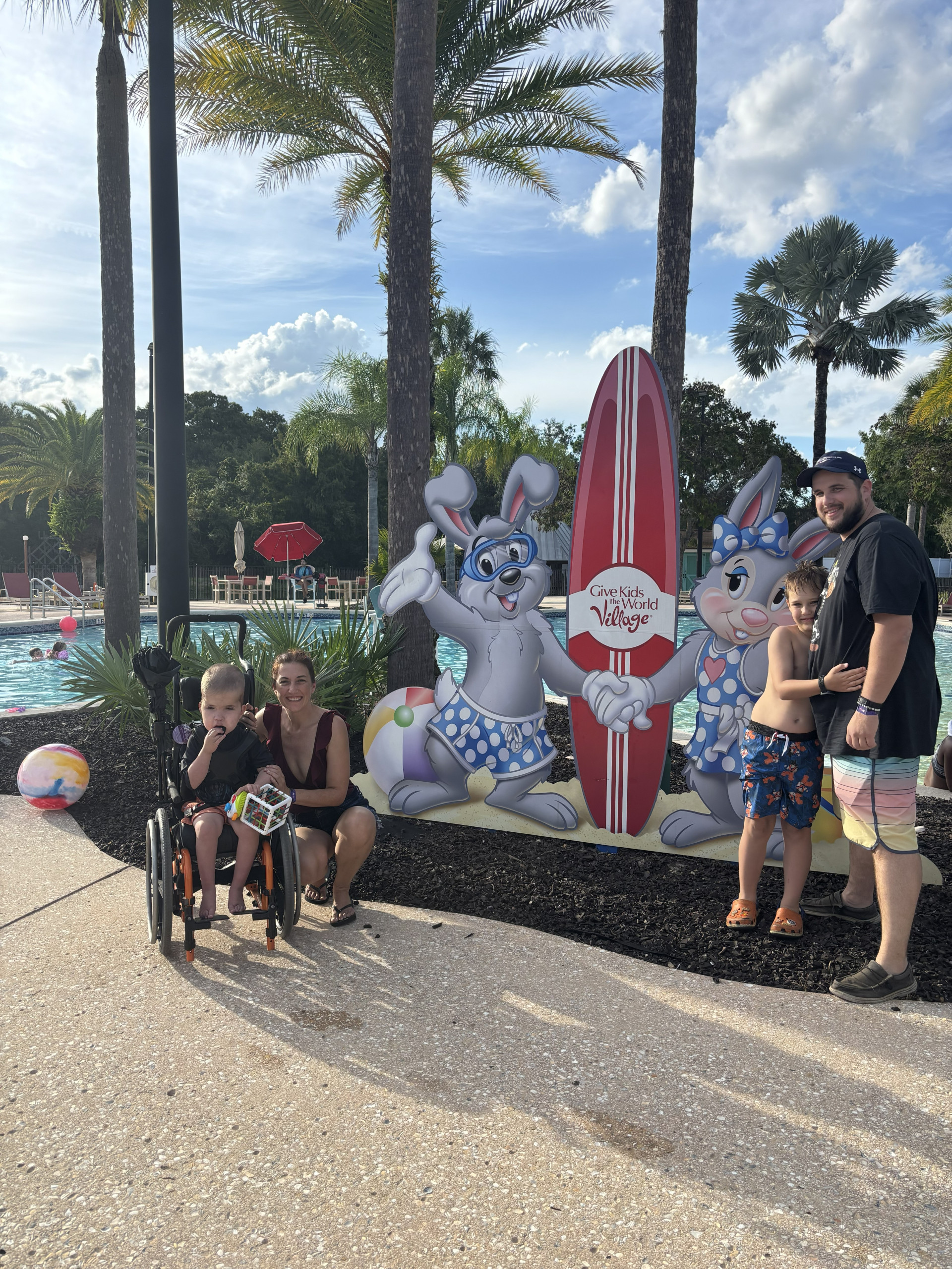 Family in front of surf board