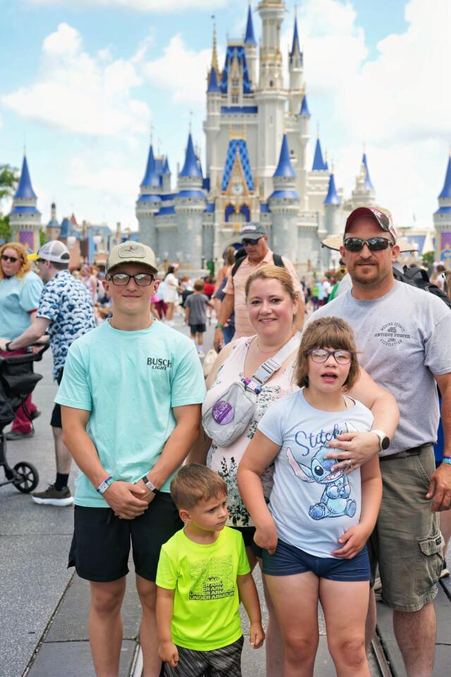 Mallory and Family in Front of Castle at Disney